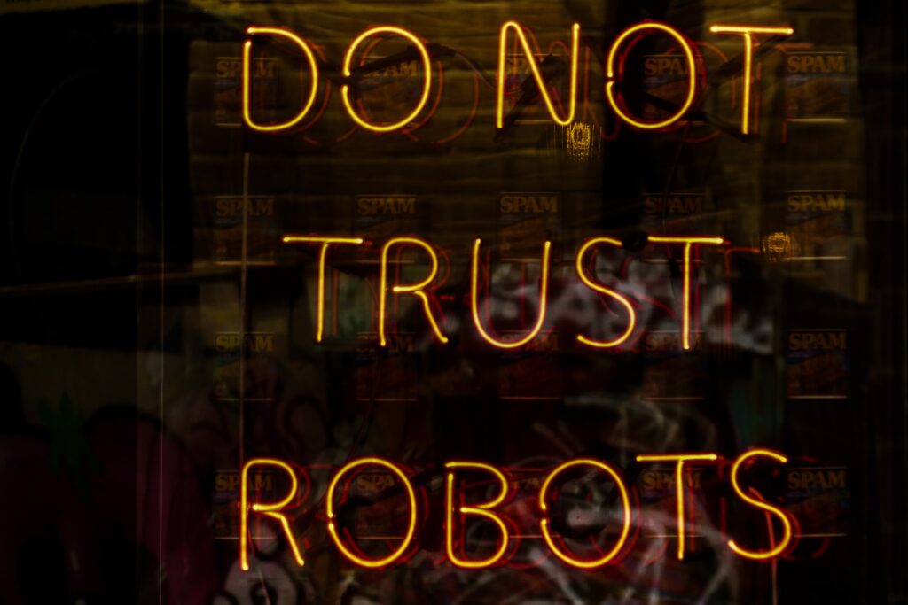 néons jaune safran formant la phrase do not trust robots